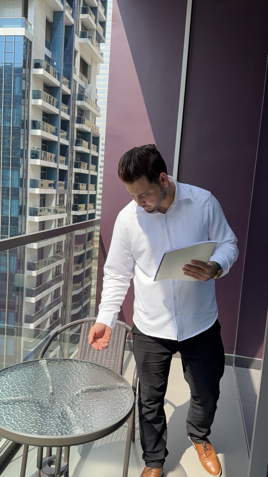 A member of the UNIT55 team checking an apartment balcony